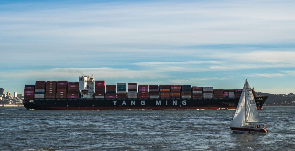 Split-screen comparison of a Docker container and a virtual machine over a code and server rack background.