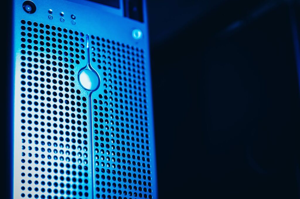 Futuristic data center with rows of servers and a single highlighted dedicated server glowing bright.