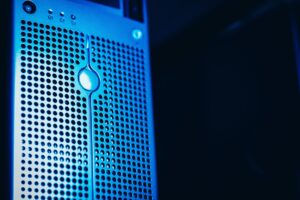 Server rack with multiple servers and a magnifying glass highlighting a single server with a puzzle piece fitting into place