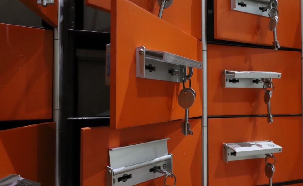 Secure server room with rows of servers and a glowing blue key inserted into a large keyhole in the foreground.